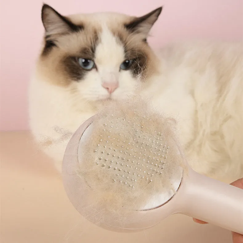 Pink cat combing brush floating needle comb for cats and dogs on white background