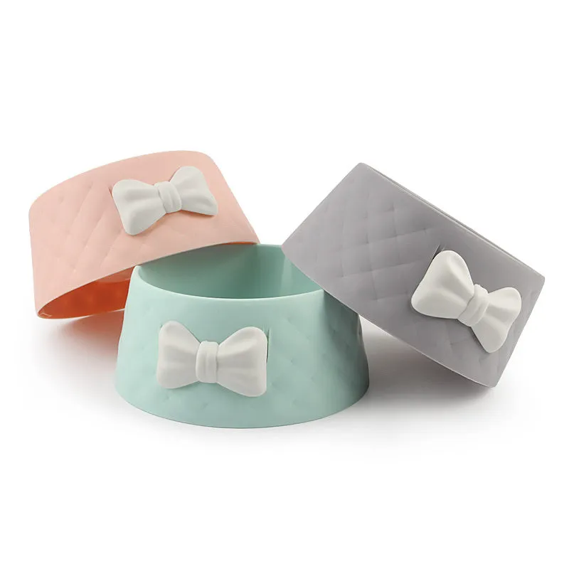 Bow shaped pet feeding bowl in PP plastic available in pink, green, and grey