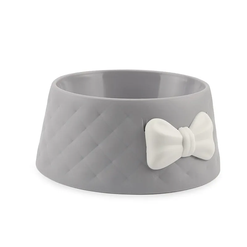 Bow shaped pet feeding bowl in PP plastic available in pink, green, and grey
