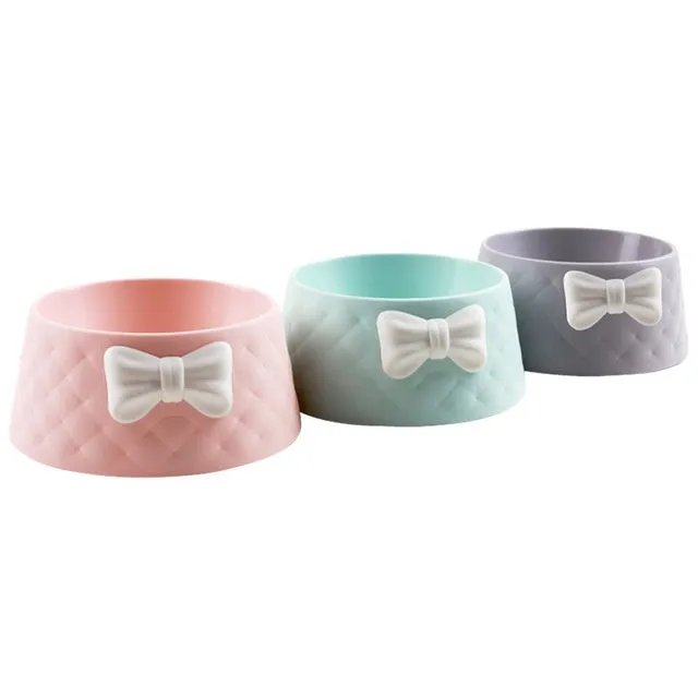 Bow shaped pet feeding bowl in PP plastic available in pink, green, and grey