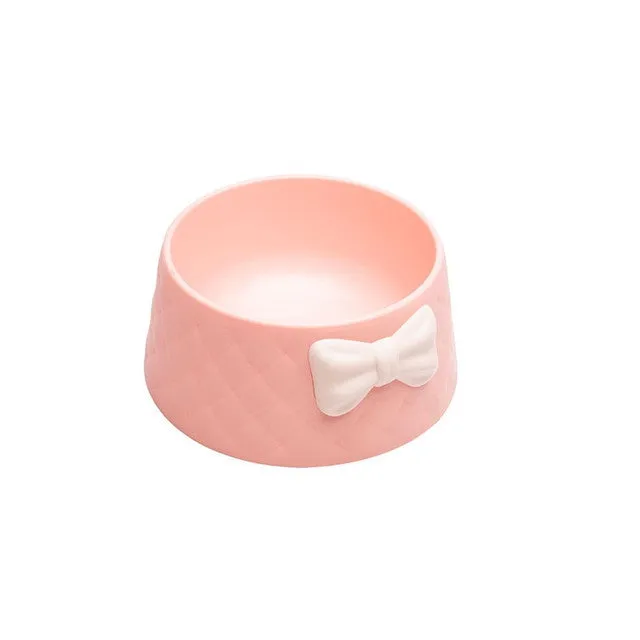 Bow shaped pet feeding bowl in PP plastic available in pink, green, and grey