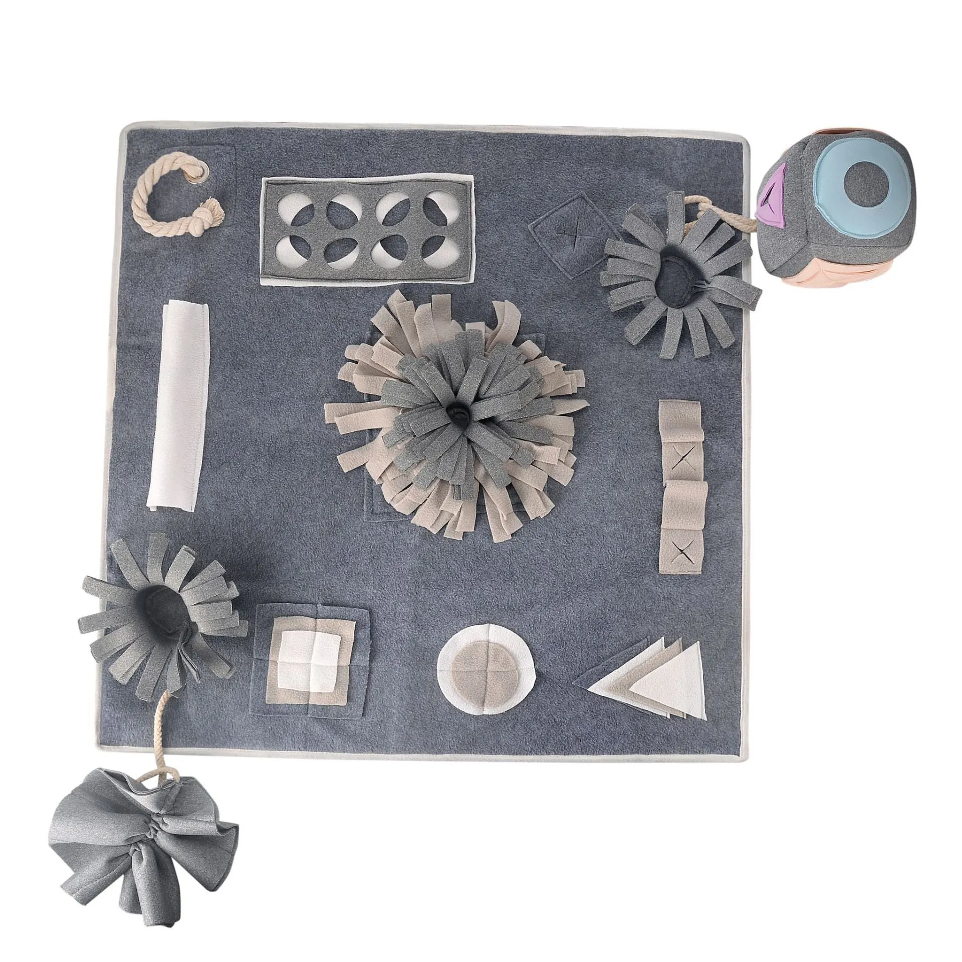 Grey cloth pet sniffing pad with two snuffle toys on a surface, designed for dog foraging and stress relief