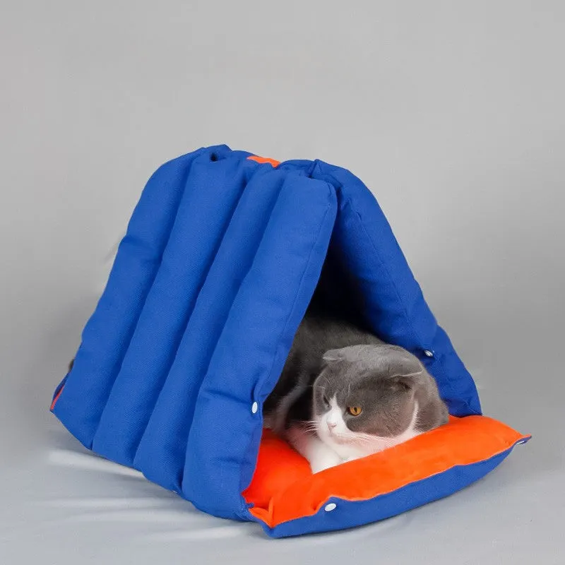 Blue triangular cat bed with raised sides and visible connection holes on a wooden floor.