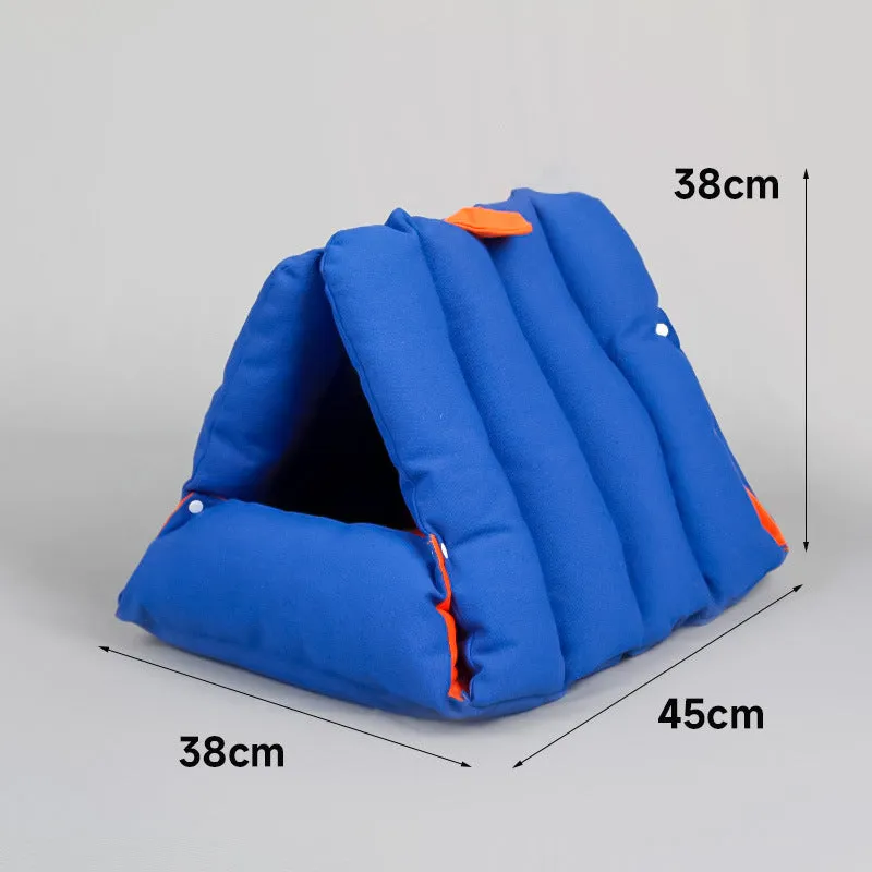 Blue triangular cat bed with raised sides and visible connection holes on a wooden floor.