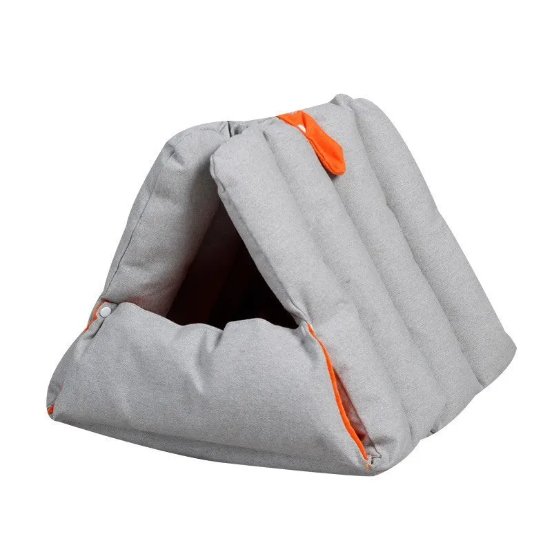 Blue triangular cat bed with raised sides and visible connection holes on a wooden floor.