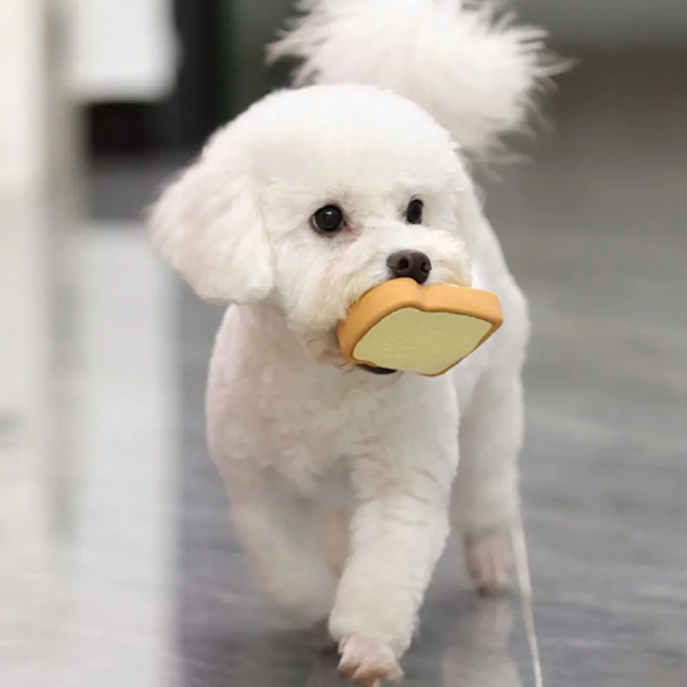 Yellow and green latex dog chew toy shaped like an egg bread with a cartoon puppy pattern.