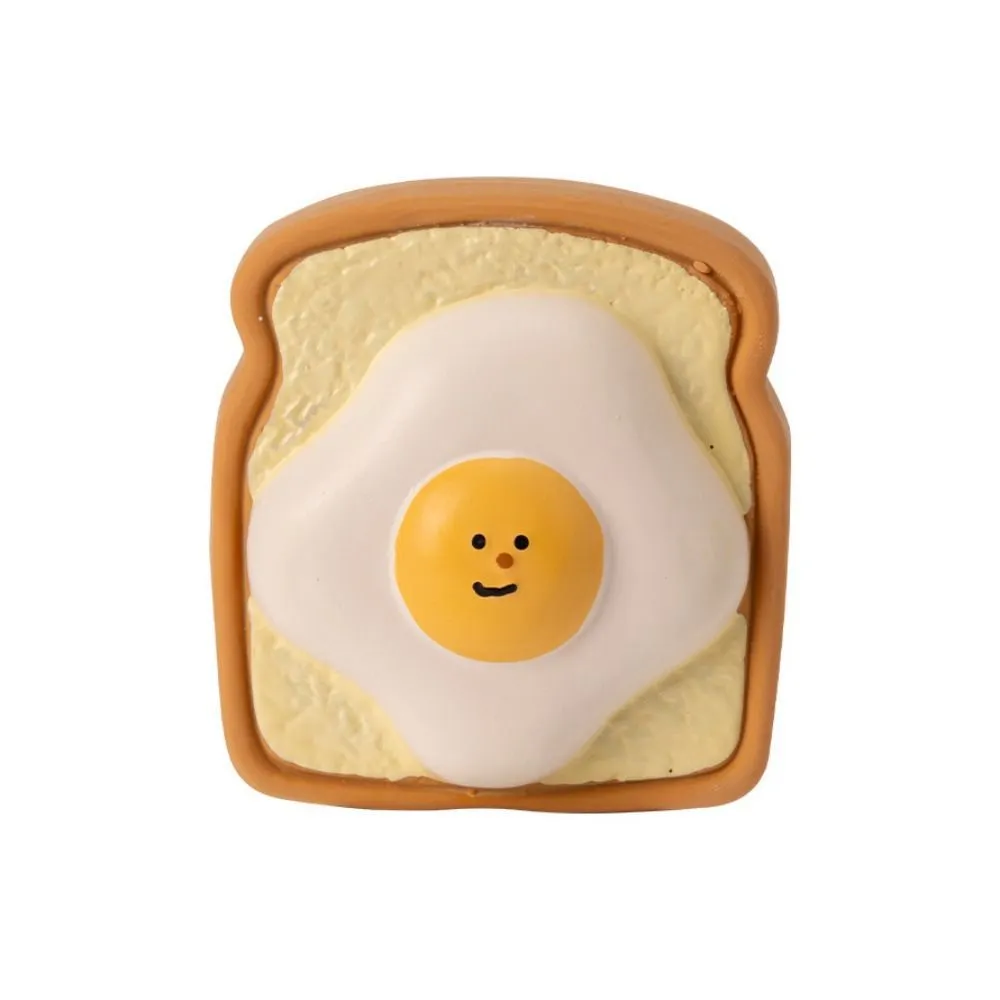 Yellow and green latex dog chew toy shaped like an egg bread with a cartoon puppy pattern.
