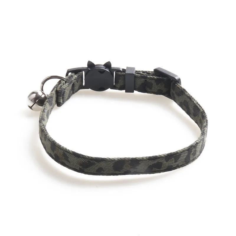 Brown cloth cat collar with attached bell on a white background