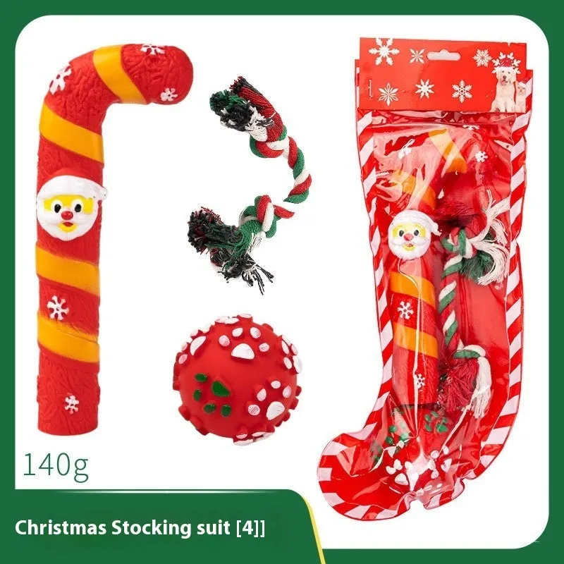 Seven sets of Christmas-themed vinyl dog toys including barbells, balls, ropes, and Santa figures.