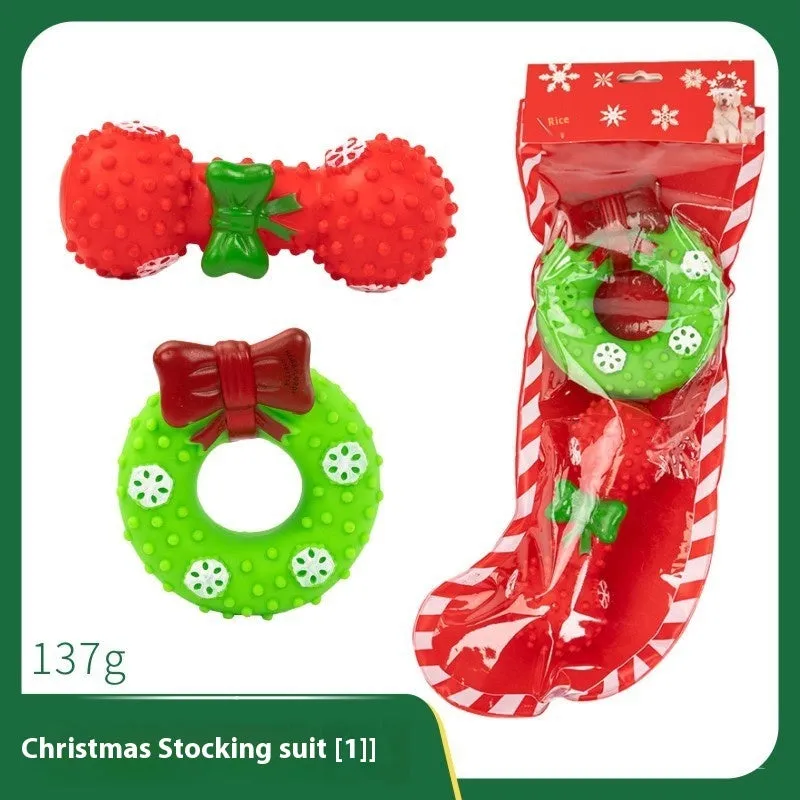 Seven sets of Christmas-themed vinyl dog toys including barbells, balls, ropes, and Santa figures.