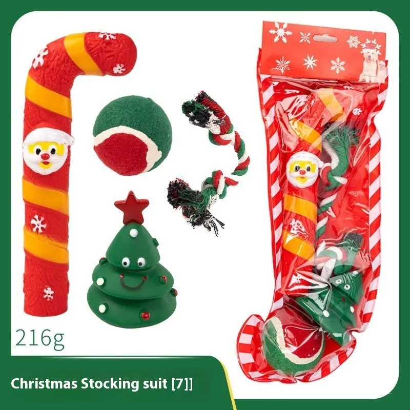Seven sets of Christmas-themed vinyl dog toys including barbells, balls, ropes, and Santa figures.