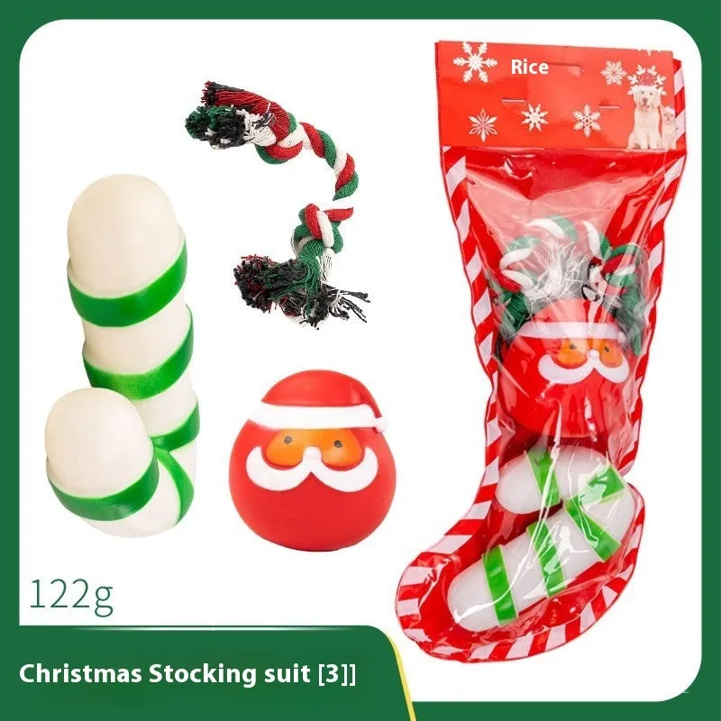 Seven sets of Christmas-themed vinyl dog toys including barbells, balls, ropes, and Santa figures.