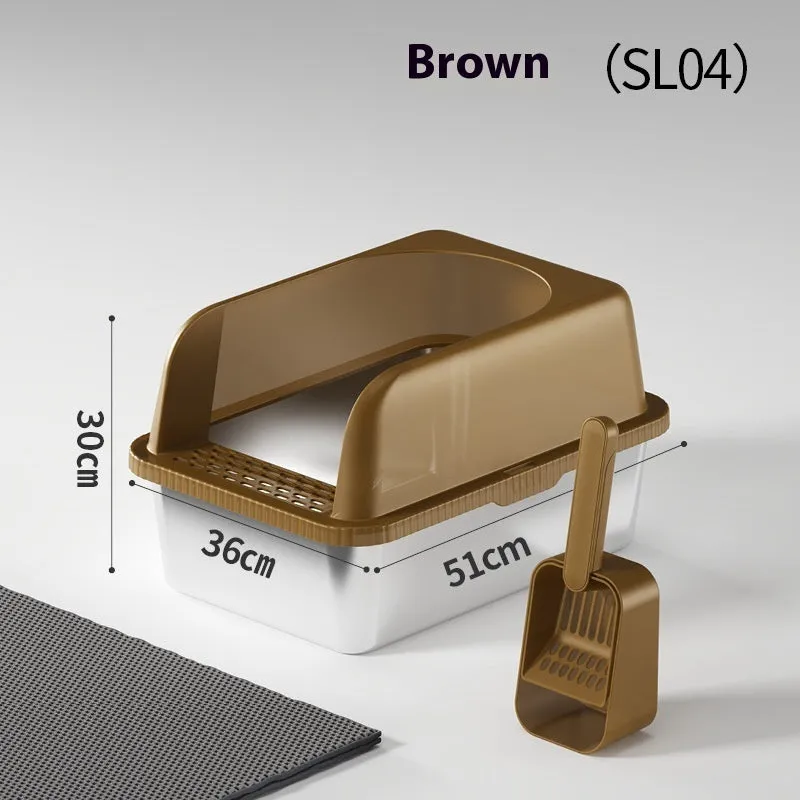Dark gray stainless steel double-layer cat litter box with sand pad and scoop on a mat – medium size