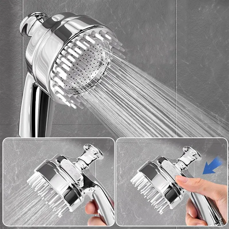 Silver dog shower attachment with soft silicone comb teeth and ergonomic grip on a white background