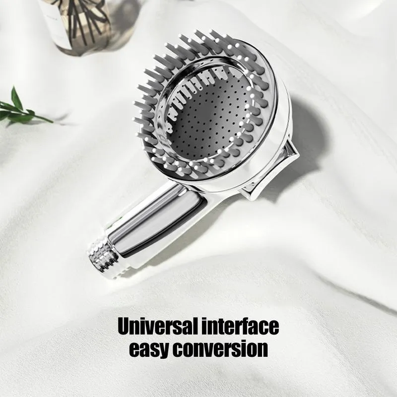 Silver dog shower attachment with soft silicone comb teeth and ergonomic grip on a white background