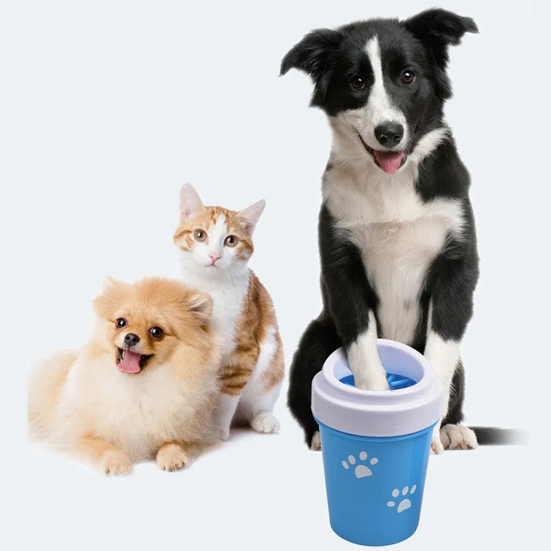 Blue silicone dog paw cleaner cup with soft bristles and easy-grip design on a white surface