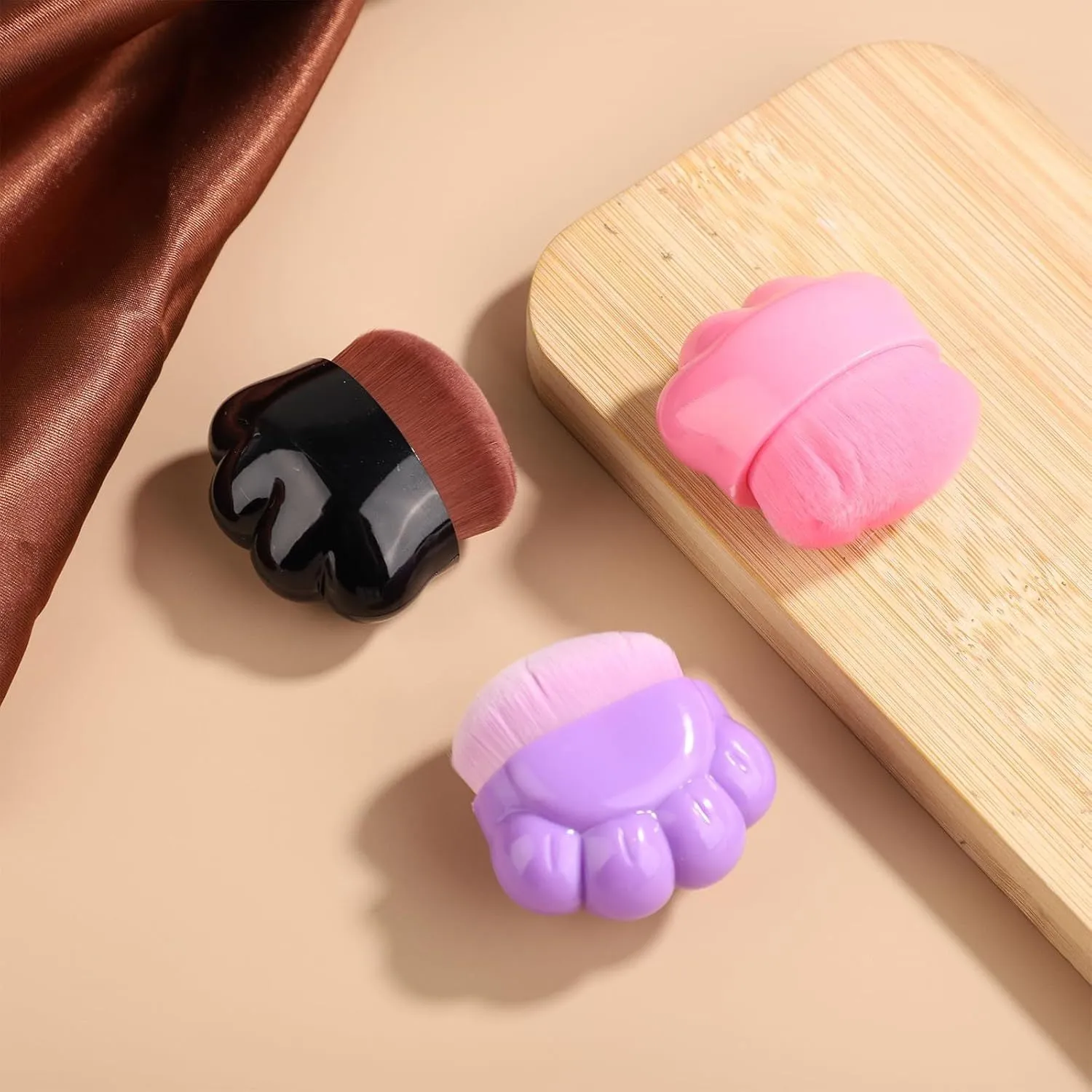 Set of three paw-shaped pet balm brushes with individual plastic storage boxes.