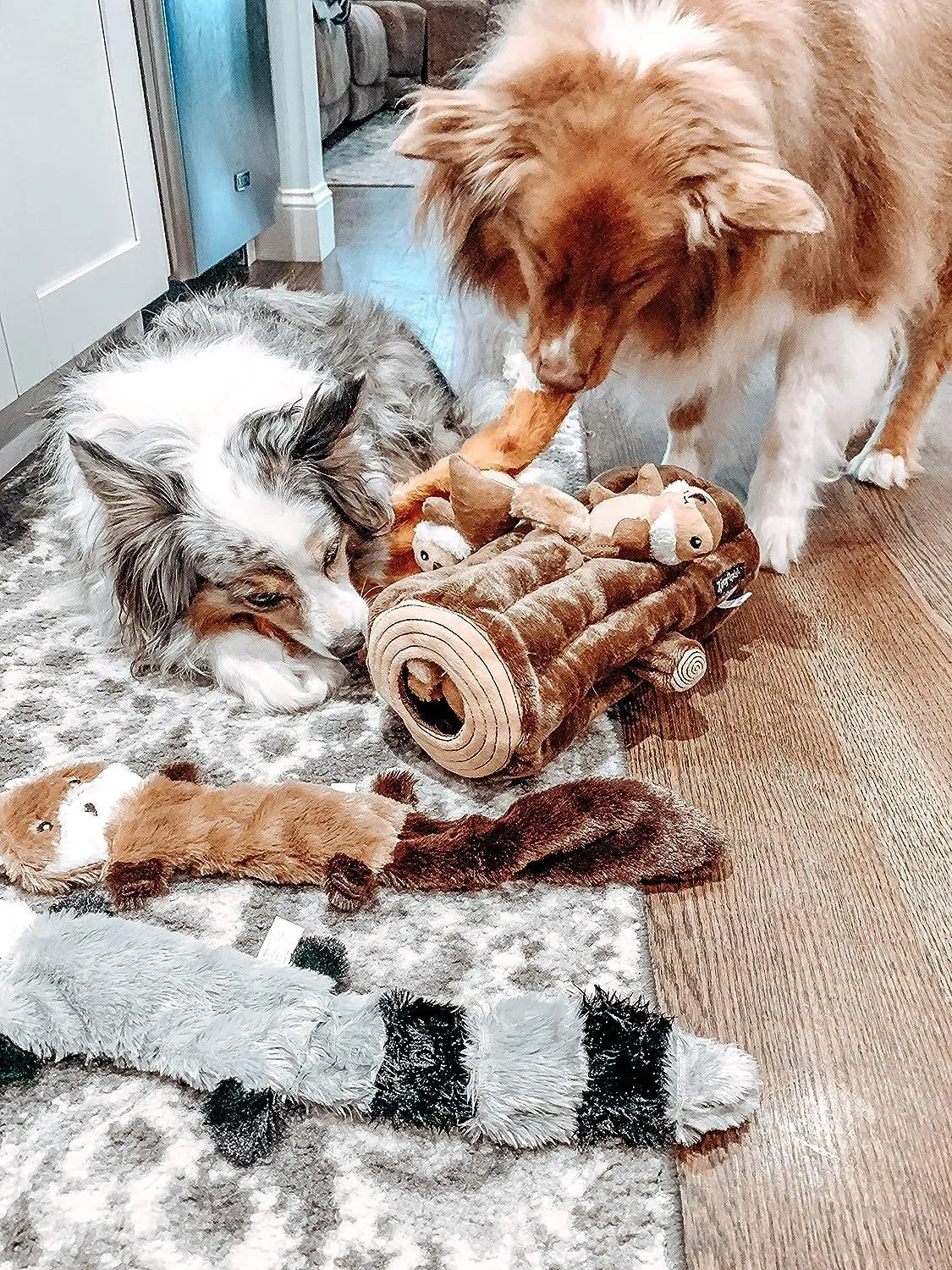 Set of three Peltz unstuffed squeaky dog toys - fox, raccoon, and squirrel - 18 inches long on white background