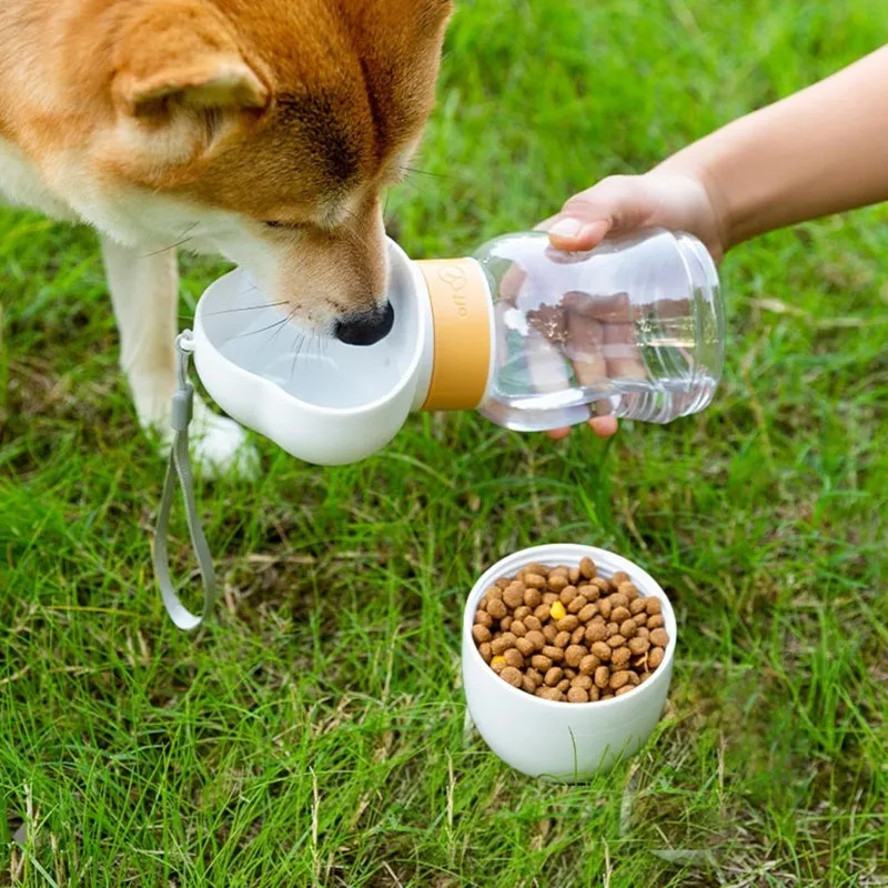 Portable dog water bottle with plastic body, rotary switch, and attached belt, showing water dispenser and bottom food container