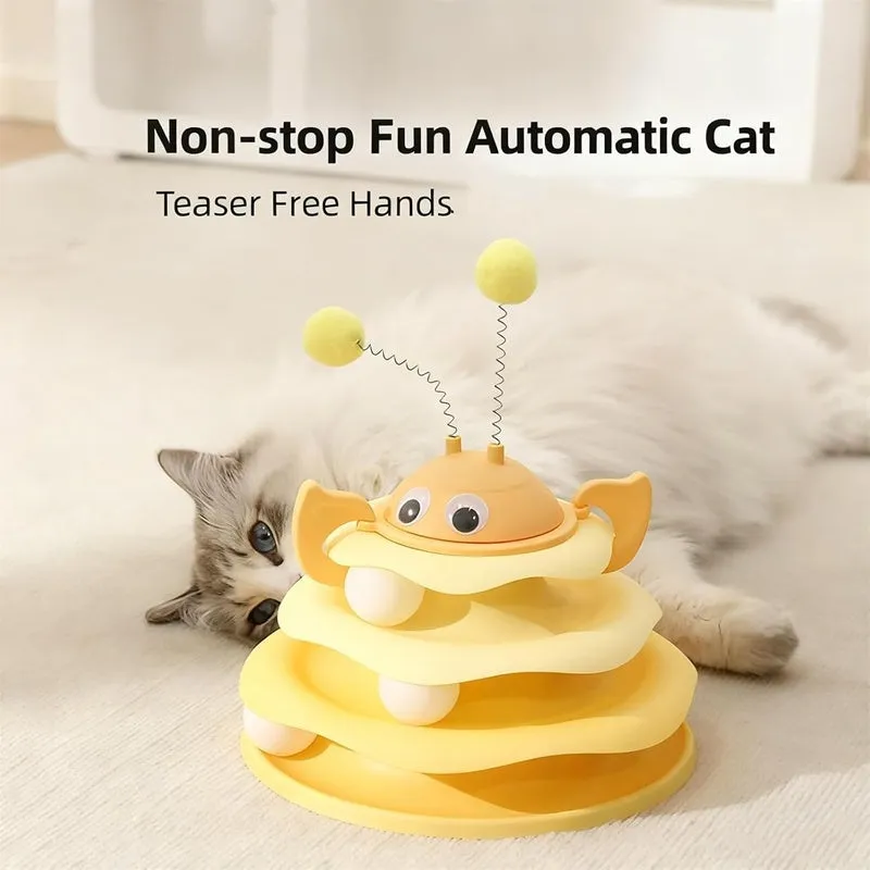 Cat toy tower with rotating bee toy and three-layer trackball in green plastic, placed on a wooden floor
