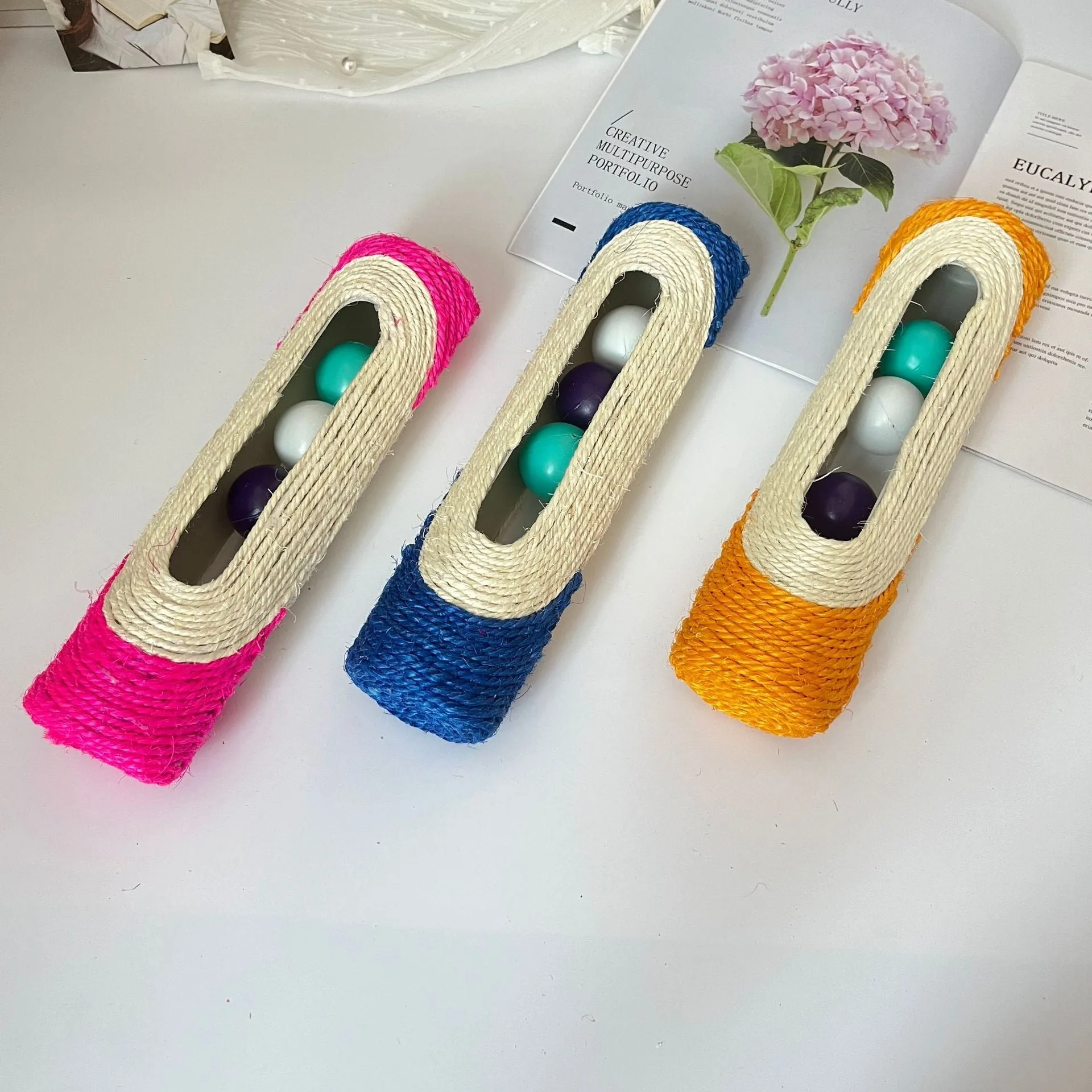 Sisal cat toy with plastic ball in blue colour, 28.5cm long, on white background