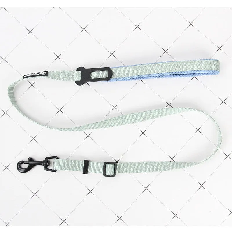 Nylon adjustable dog breast strap with hand holding rope in blue pink colour on white background