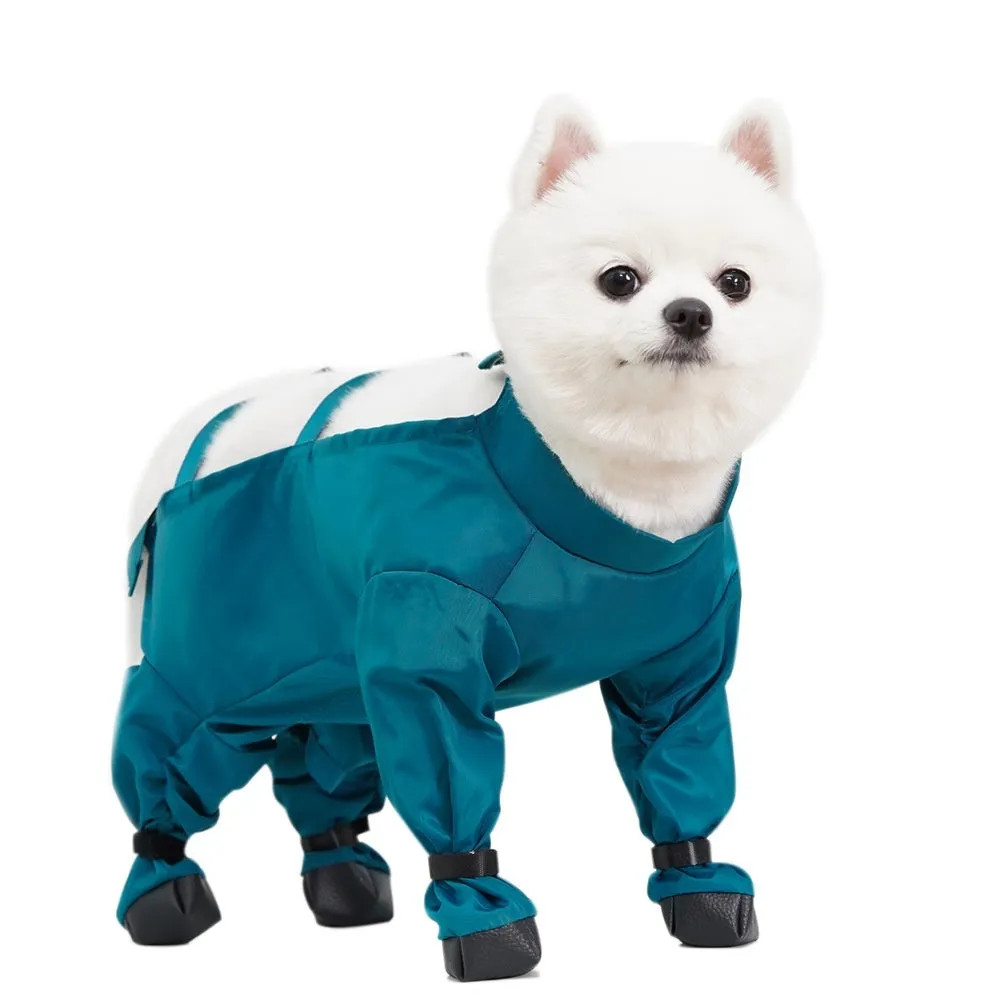Peacock blue pet diaper bag belly jumpsuit made of waterproof memory cloth, laid flat showing foot-wrapped design