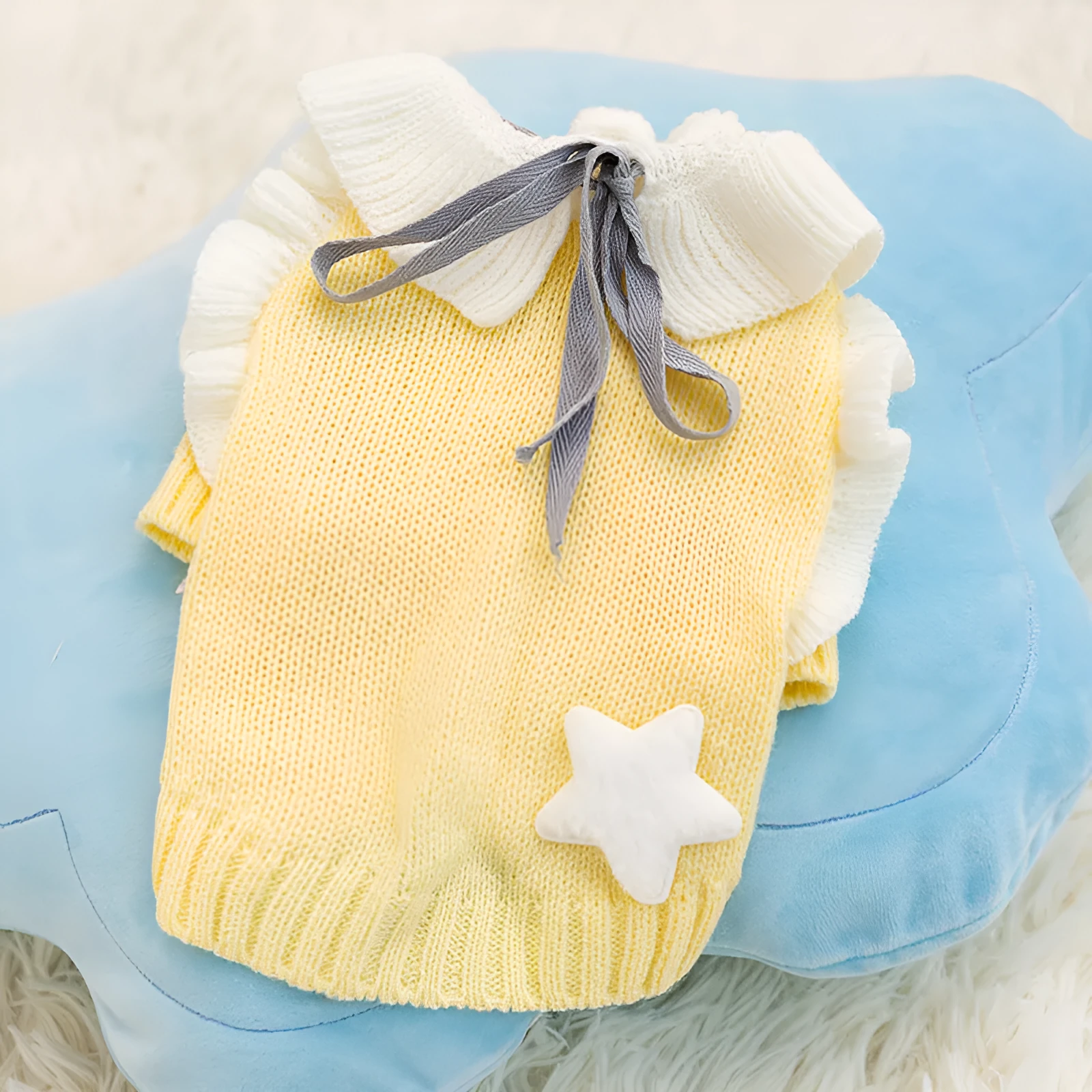 Yellow knitted dog sweater with star pattern and turtleneck on small breed puppy