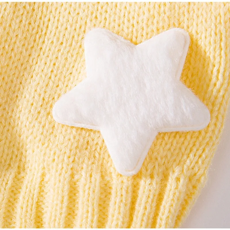 Yellow knitted dog sweater with star pattern and turtleneck on small breed puppy