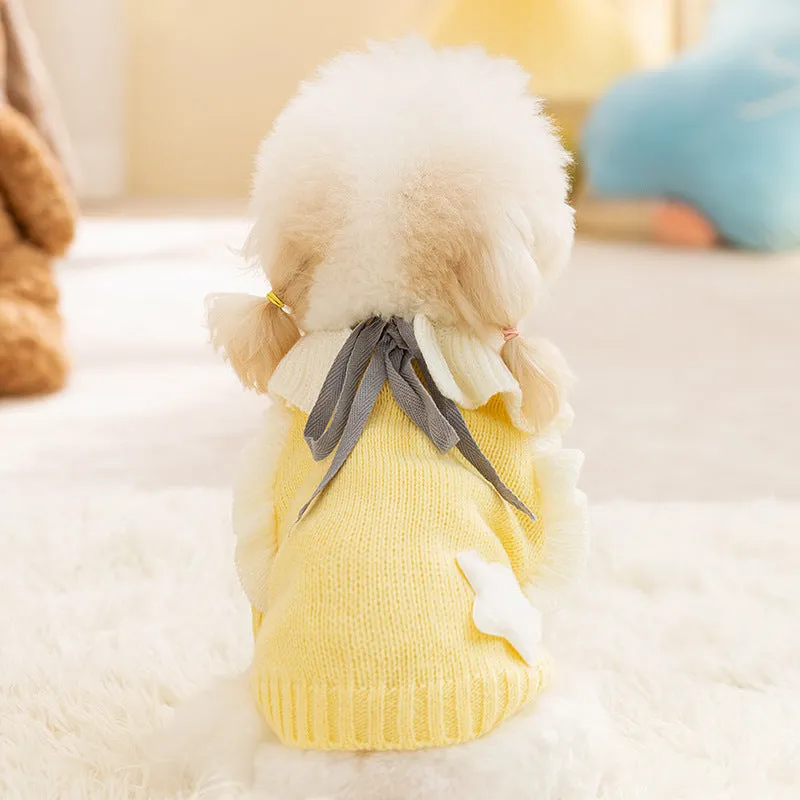 Yellow knitted dog sweater with star pattern and turtleneck on small breed puppy