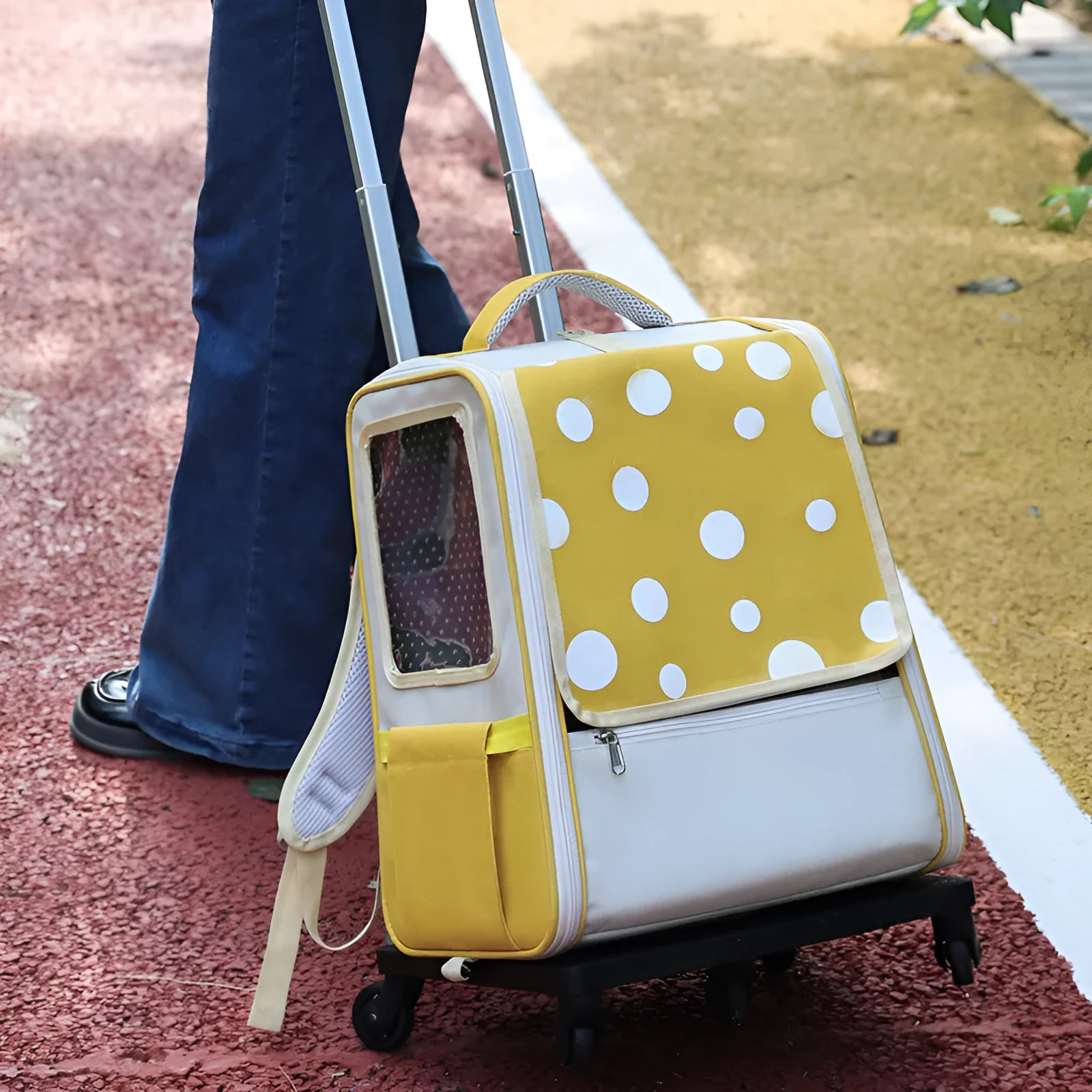 Multifunctional draw-bar pet bag in 1012 Blue with polka dot pattern, side view showing wheels and handle for rolling
