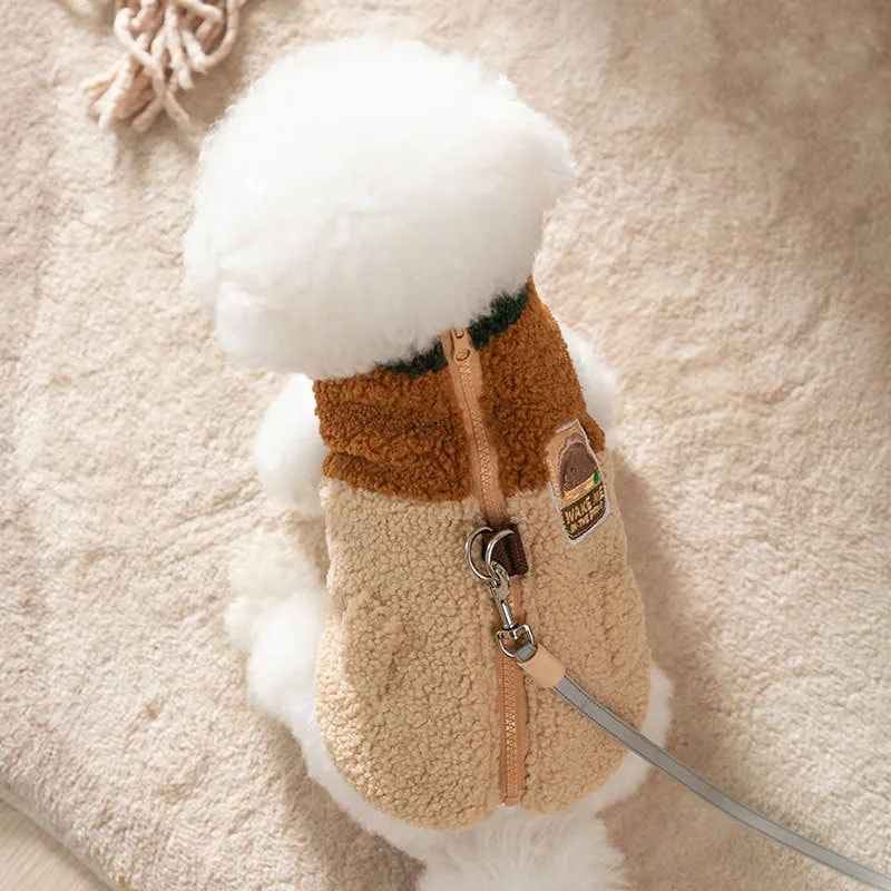 Colour-block pet fleece jacket with squirrel patch, leash ring, and pockets in green, brown, and beige on a small dog.