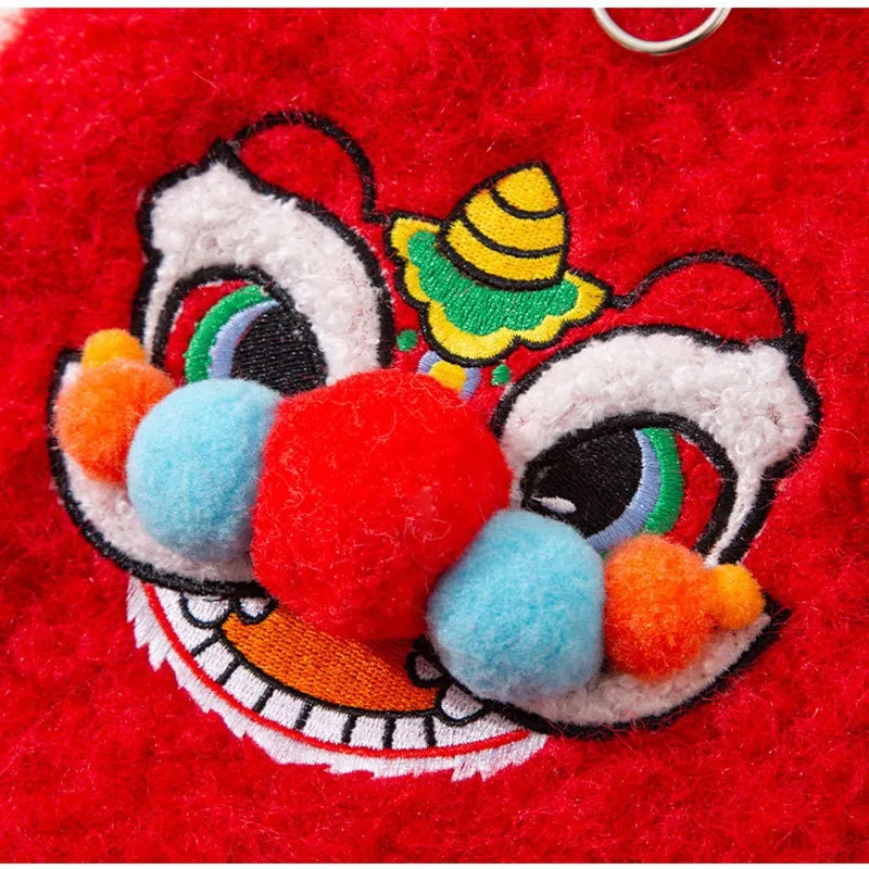 Red pet lion dance sweater with 3D face, colourful pom-poms, and leash ring on small dog
