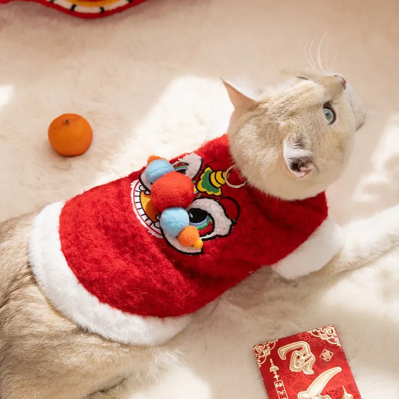 Red pet lion dance sweater with 3D face, colourful pom-poms, and leash ring on small dog
