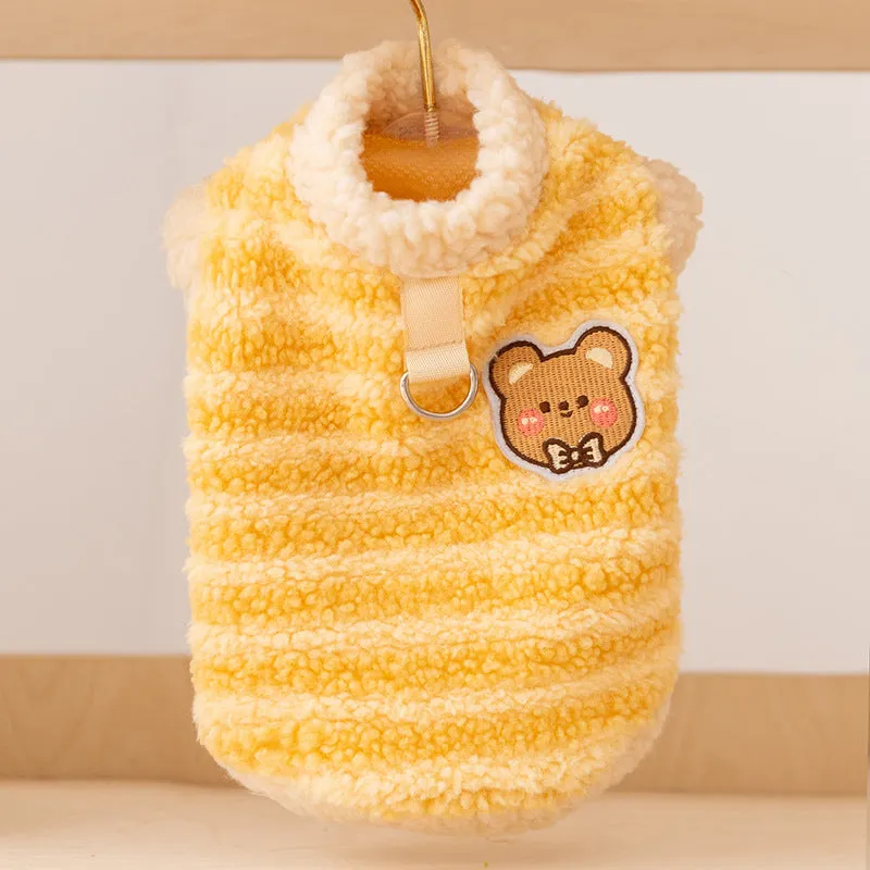Yellow striped lambskin fleece dog clothing with bear patch and leash ring on a small dog