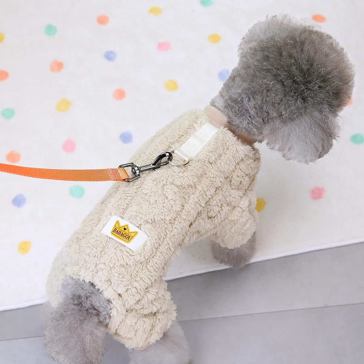 Four-legged dog fleece jacket in khaki on a small breed dog outdoors