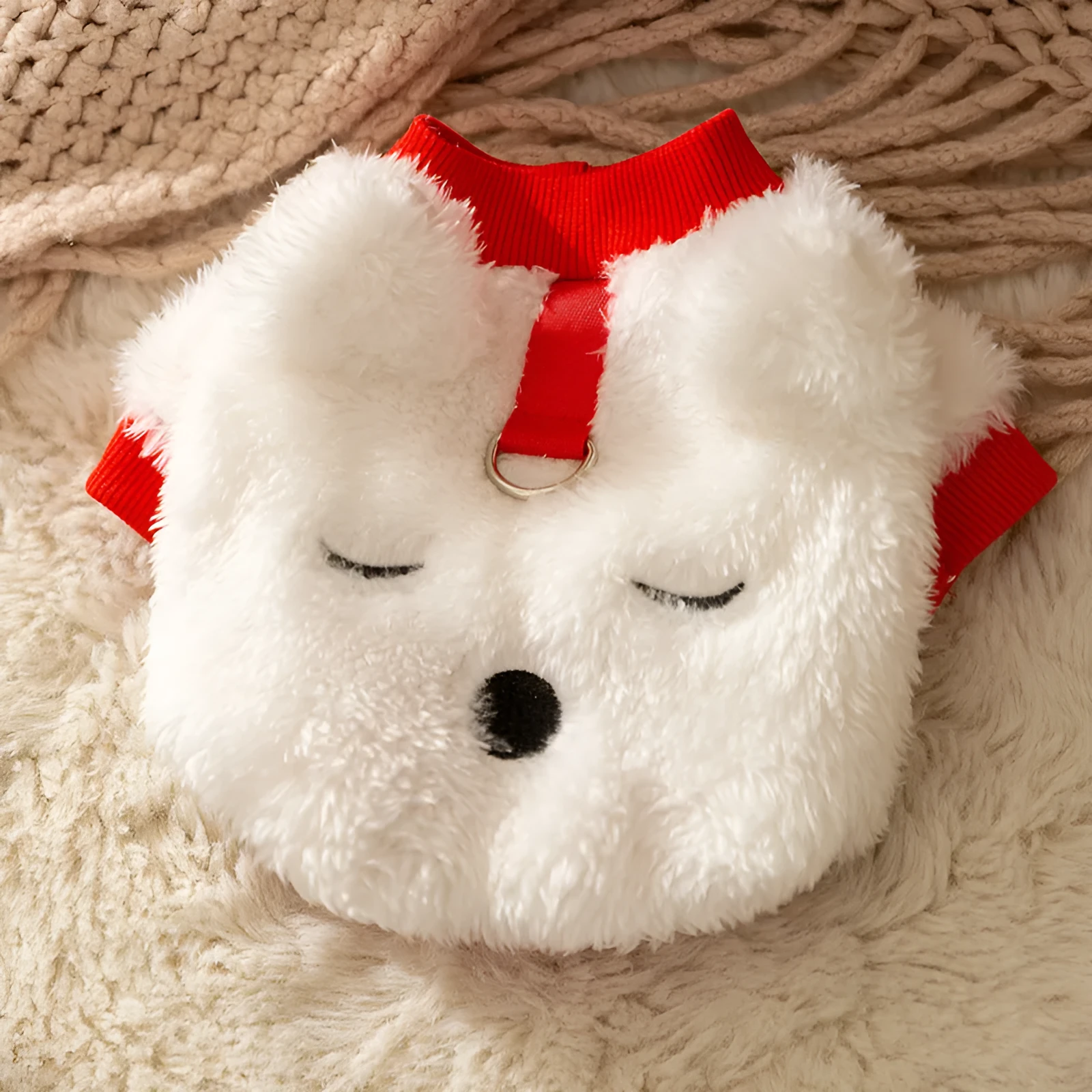 White plush bear pet jacket with 3D bear face, closed eyes, red knit trim, and metal leash ring for small dogs