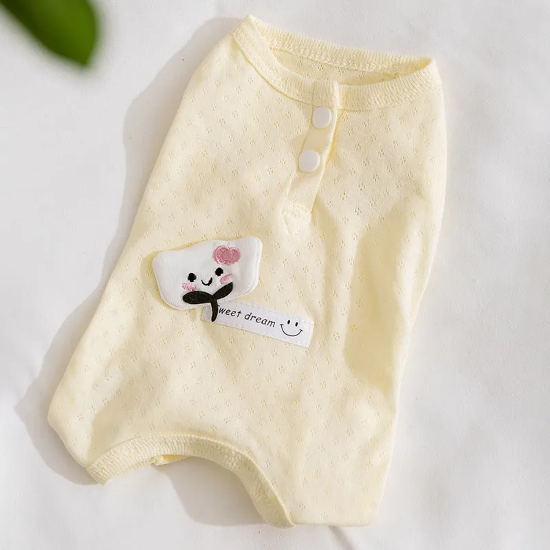 Soft yellow mesh pet shirt with cartoon cat patch and button closure on a small dog or cat