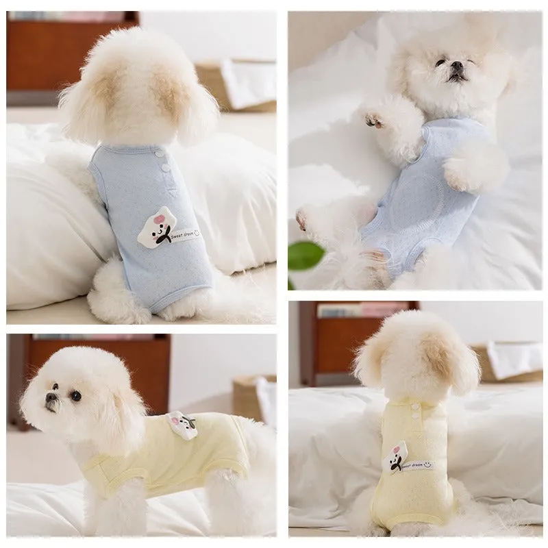 Soft yellow mesh pet shirt with cartoon cat patch and button closure on a small dog or cat