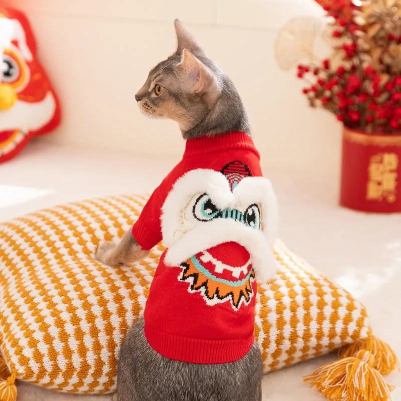 Red knitted lion dance pet sweater with 3D plush face details and colourful embroidery on a cat
