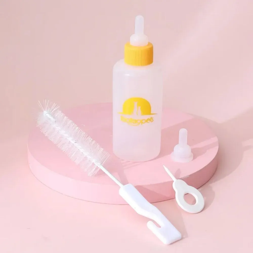 Set of four coloured pet milk bottles and a cleaning brush for feeding small animals