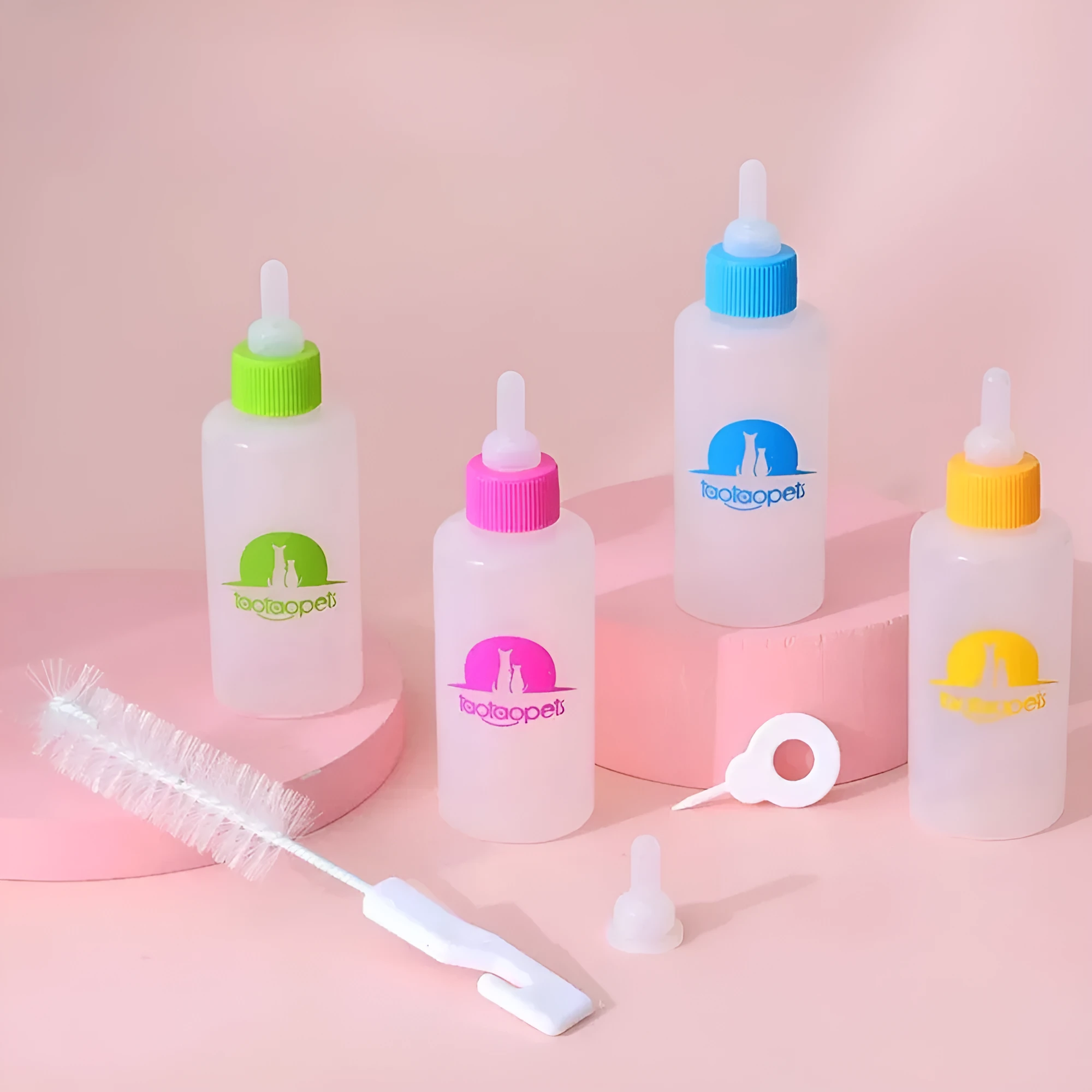 Set of four coloured pet milk bottles and a cleaning brush for feeding small animals