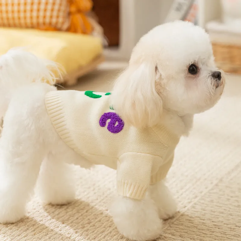 White knitted small dog sweater with rainbow Apple embroidery and green smiley face on a pet