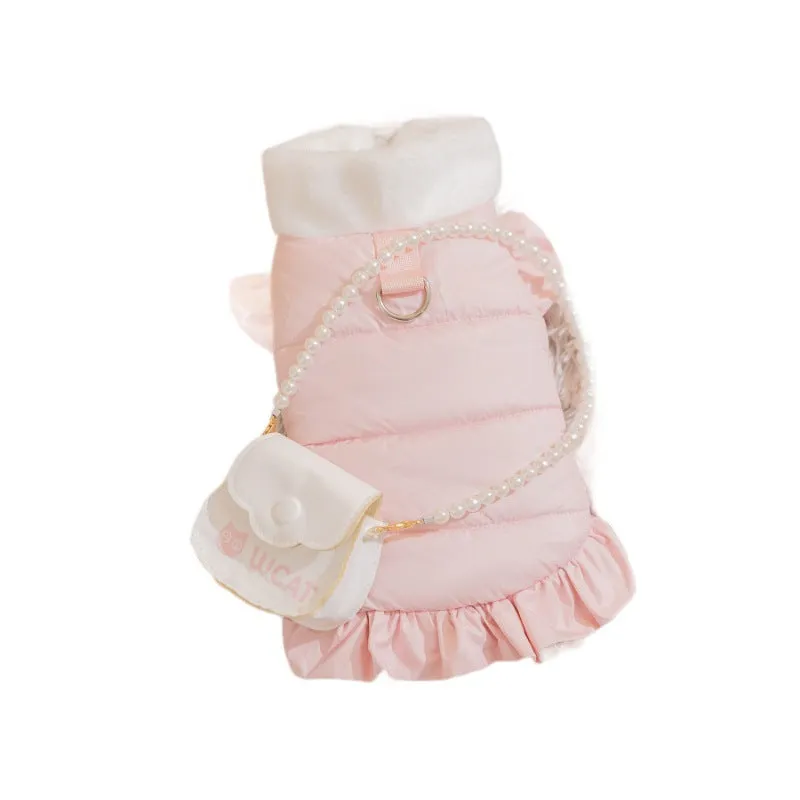 Small dog wearing a pink gingham princess skirt with built-in D-ring for leash attachment