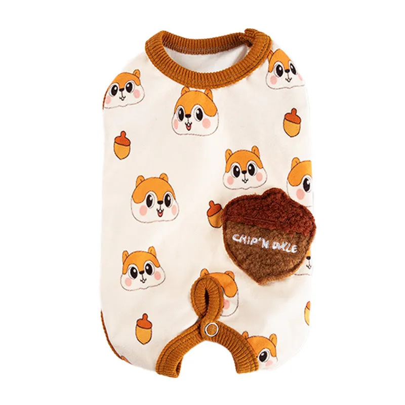 Small dog wearing Chip 'n' Dale themed cream onesie with yellow trim and embroidered acorn pocket