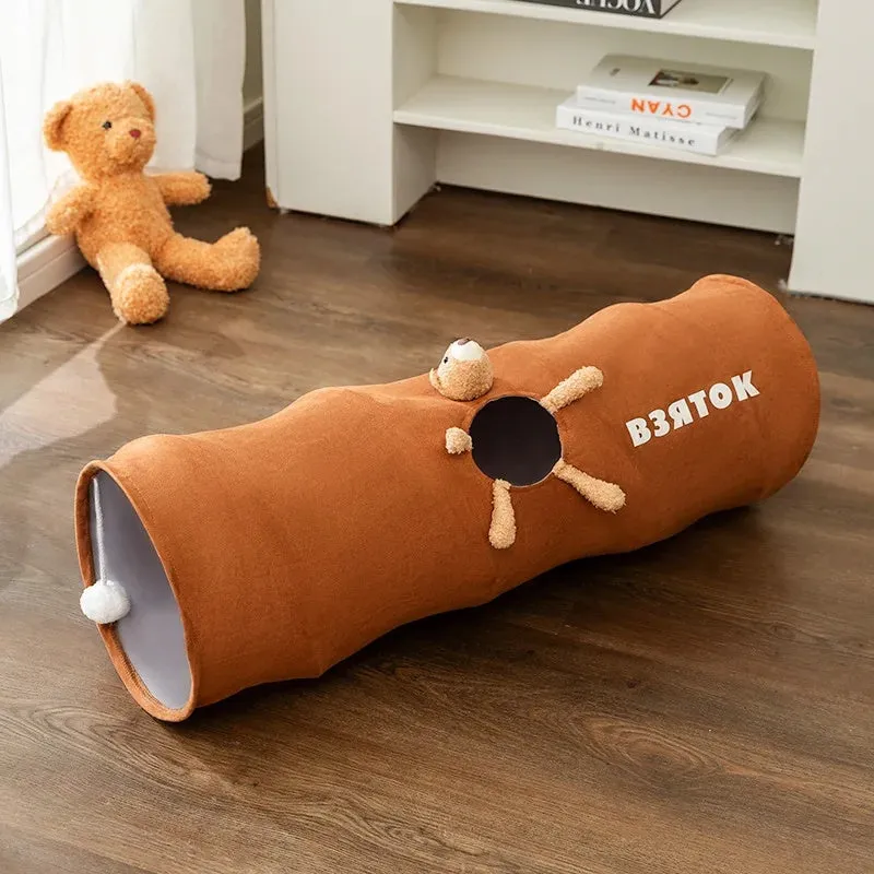 Collapsible cat tunnel with plush ball in brown or grey, showing foldable steel wire frame and suede fabric