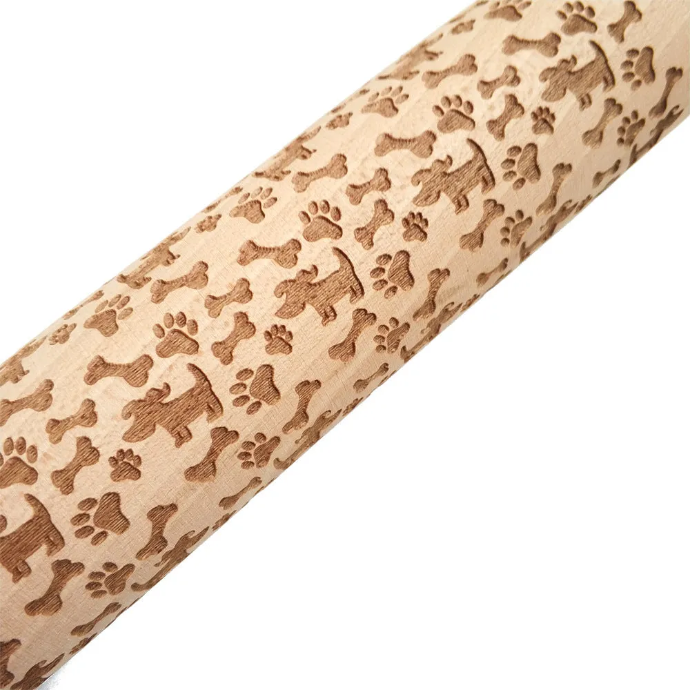Wooden rolling pin with embossed Christmas patterns, 45cm long, on a kitchen worktop.
