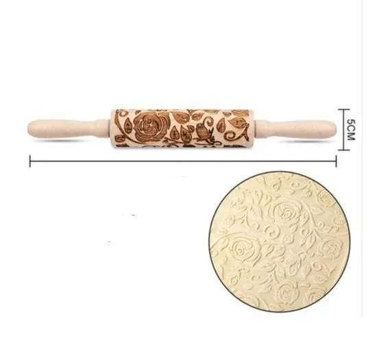 Wooden rolling pin with embossed Christmas patterns, 45cm long, on a kitchen worktop.