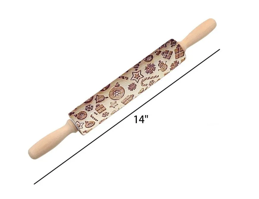 Wooden rolling pin with embossed Christmas patterns, 45cm long, on a kitchen worktop.