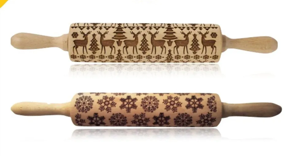 Wooden rolling pin with embossed Christmas patterns, 45cm long, on a kitchen worktop.